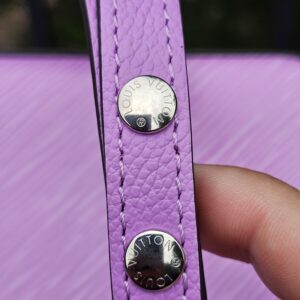 Silver-tone studs on the adjustable Epi leather strap of the Louis Vuitton Marellini