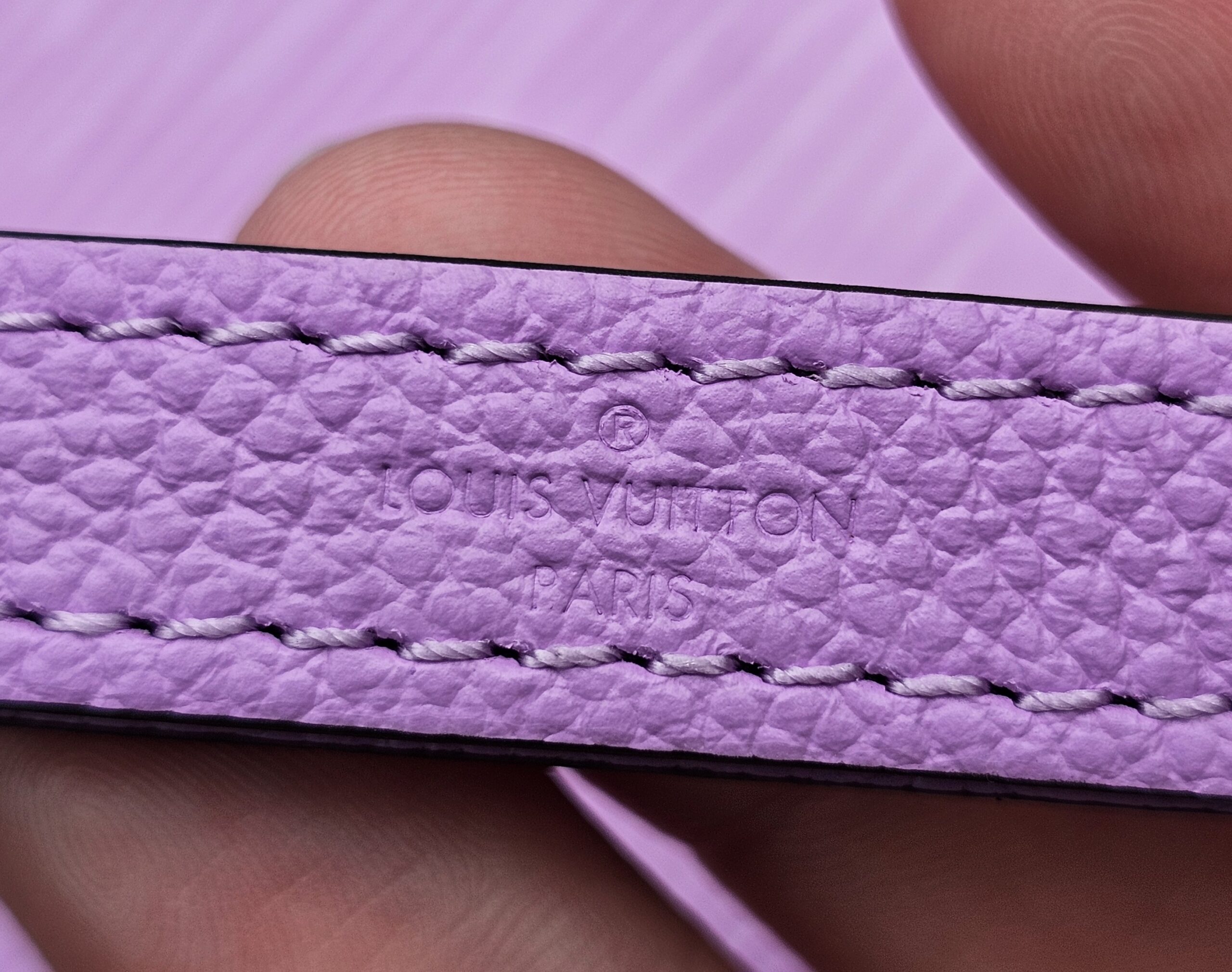 Louis Vuitton engraved on the purple Epi leather strap of the Marellini