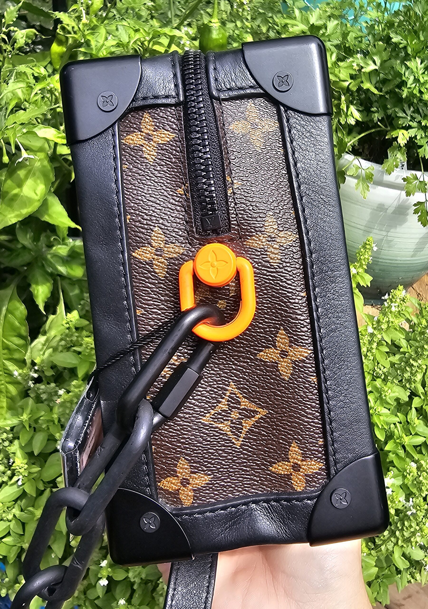 Louis Vuitton Monogram Solar Ray Soft Trunk held in hand to show scale