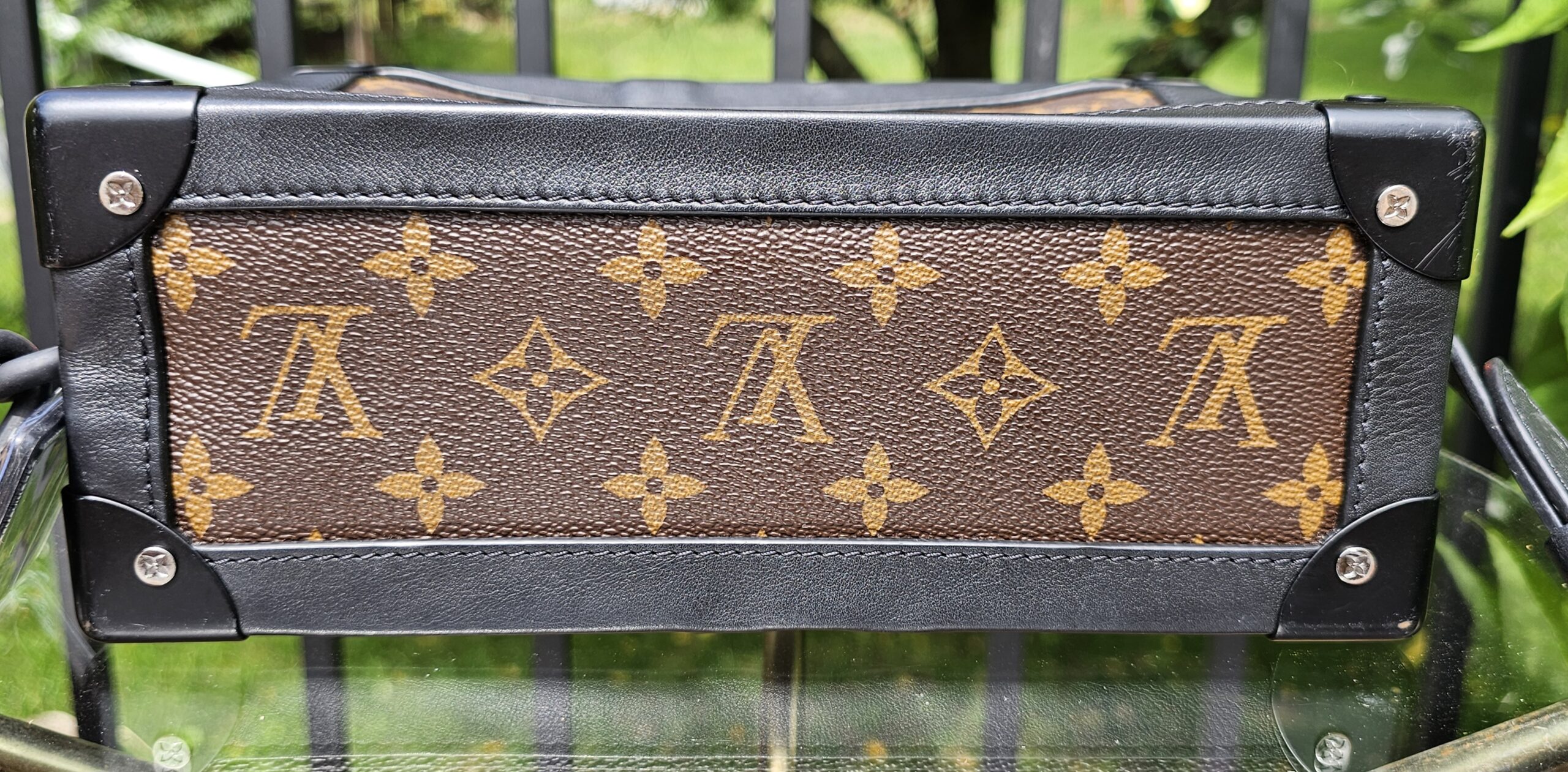Base of the Louis Vuitton Monogram Solar Ray Soft Trunk with black corner protectors