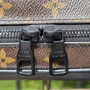 Twin black zip pulls stamped Louis Vuitton on the Monogram Solar Ray Soft Trunk