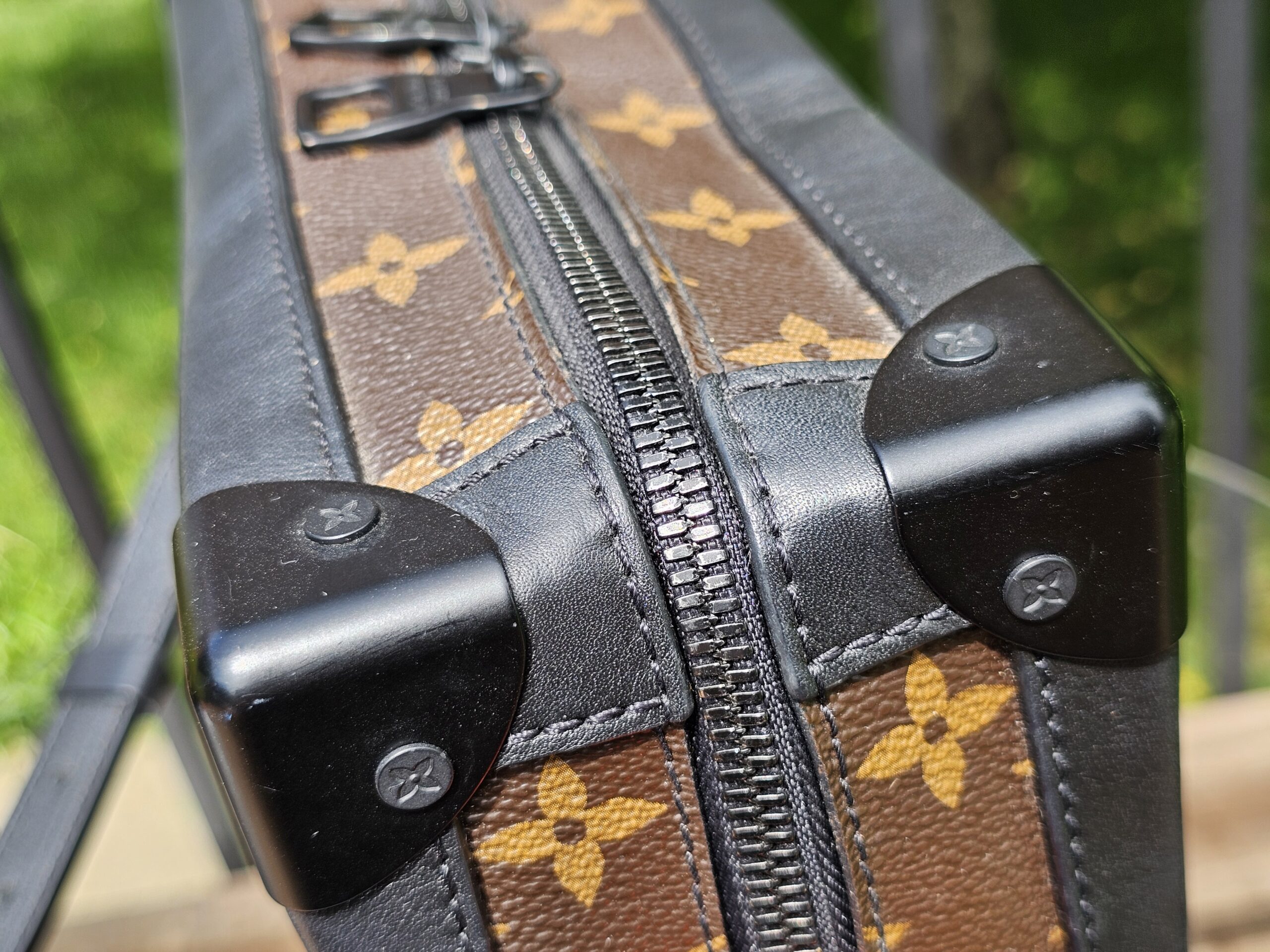Black corner protector and zip track on the Louis Vuitton Monogram Solar Ray Soft Trunk