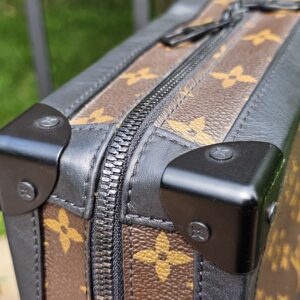 Close-up of a black trunk corner protector on the Louis Vuitton Solar Ray Soft Trunk