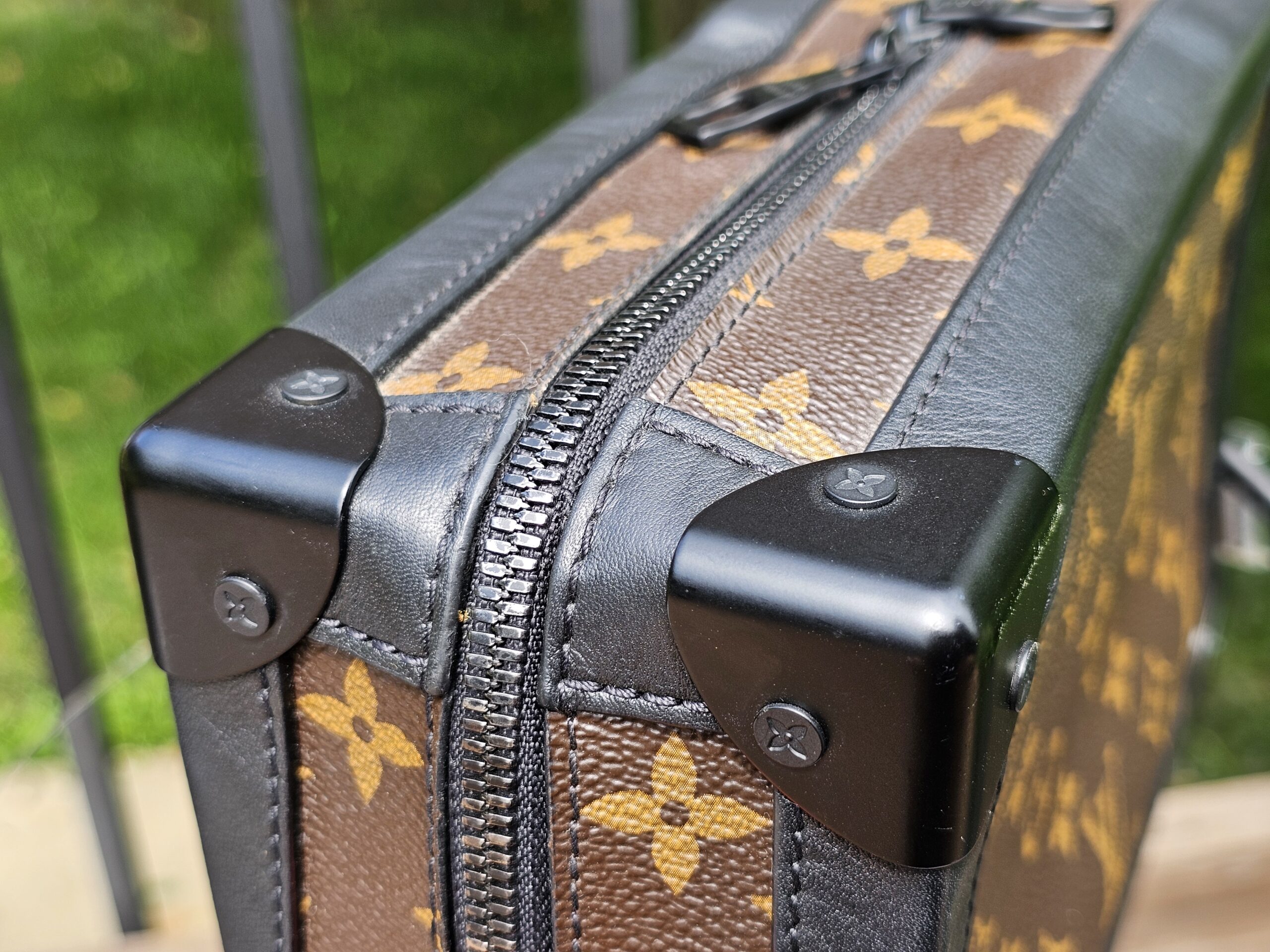 Close-up of a black trunk corner protector on the Louis Vuitton Solar Ray Soft Trunk