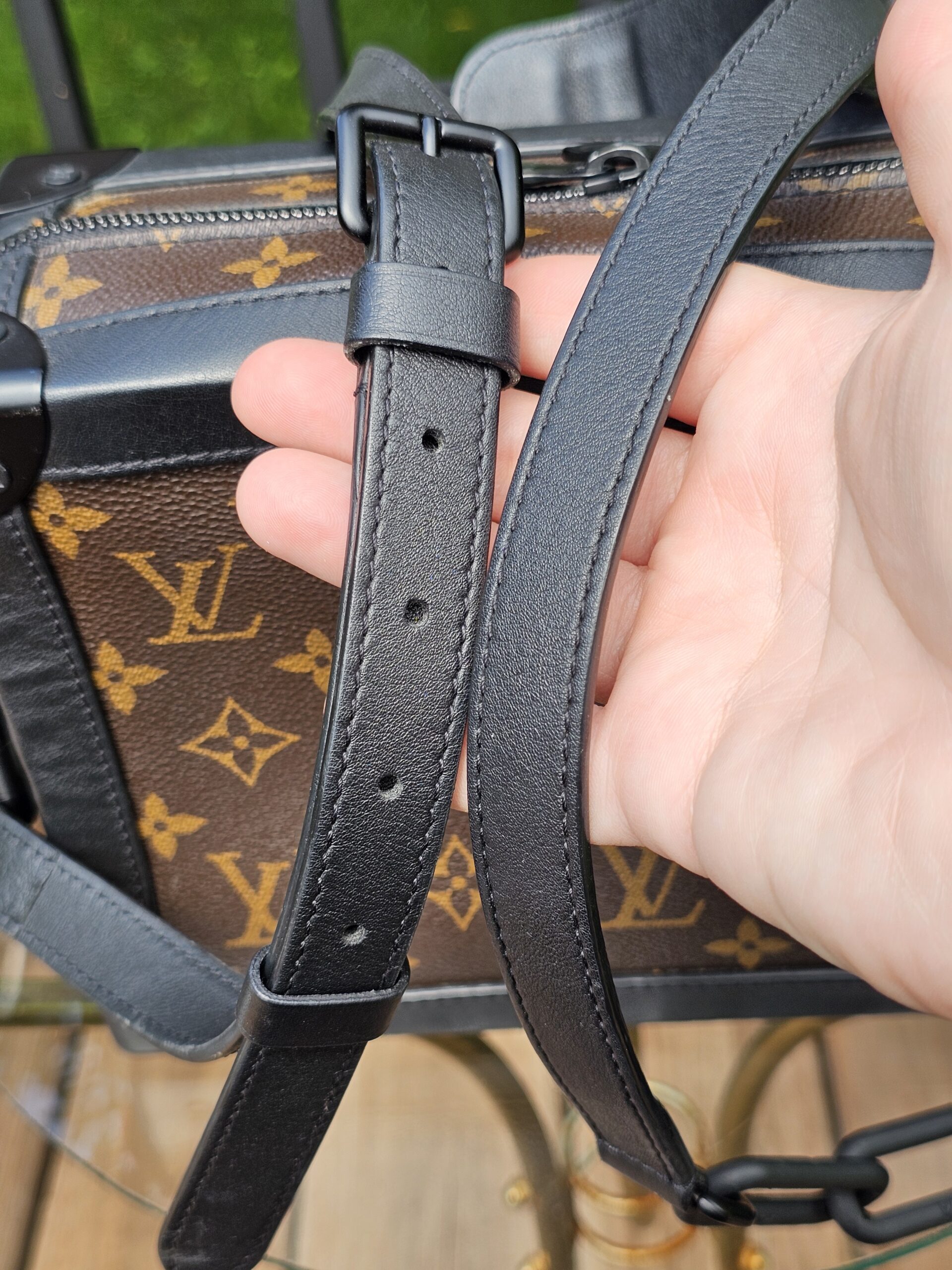 Detachable adjustable black leather strap of the Louis Vuitton Monogram Solar Ray Soft Trunk