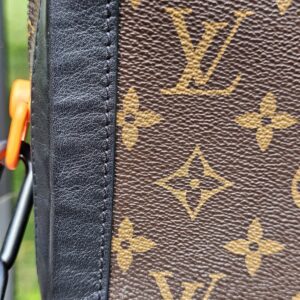 Side panel of the Louis Vuitton Monogram Solar Ray Soft Trunk with the orange accent visible