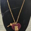 Louis Vuitton Lock Me heart necklace with burgundy resin heart, gold-tone S-lock and key charm on a gold chain