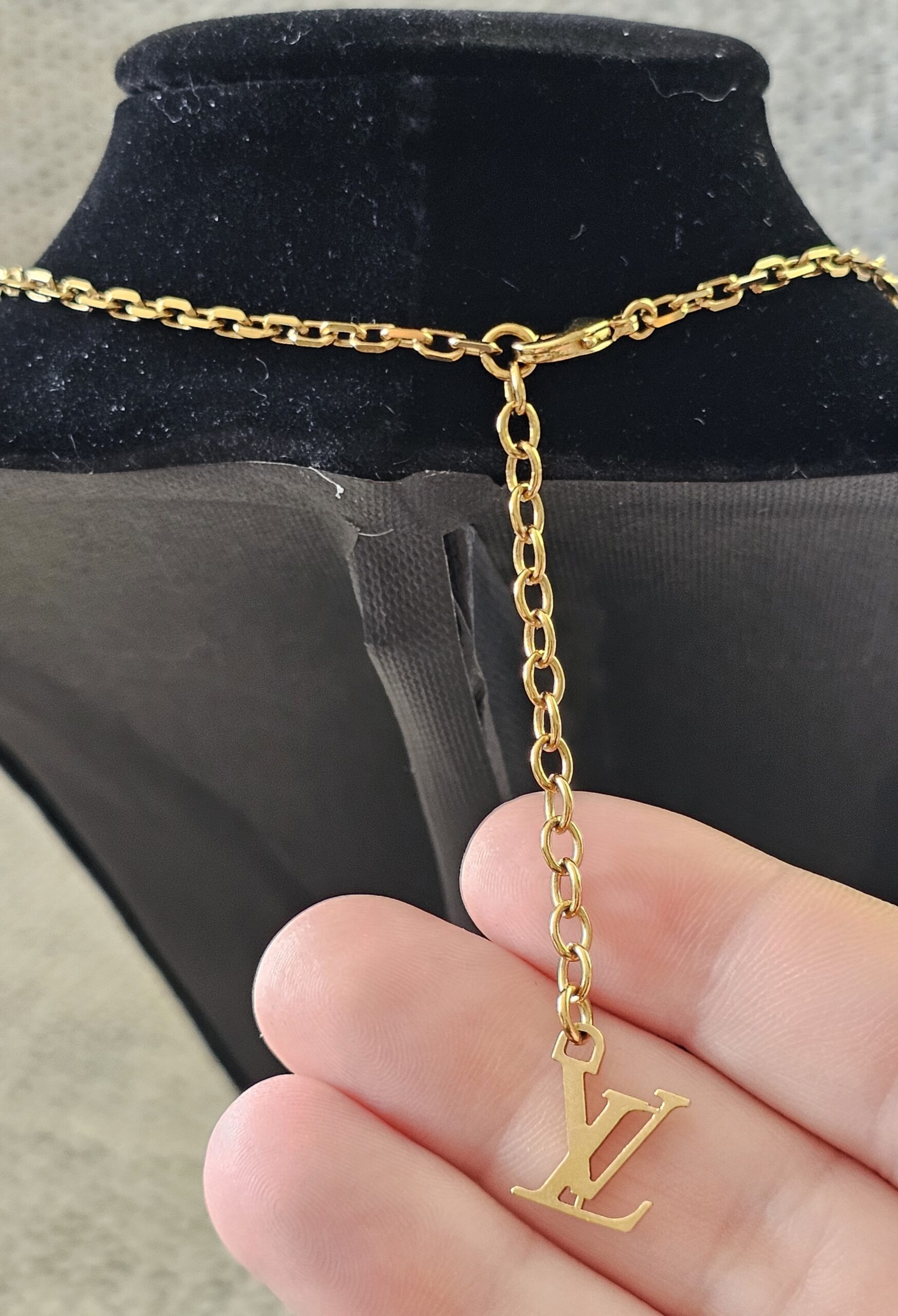 LV logo extender on the adjustable chain of the Louis Vuitton Lock Me heart necklace