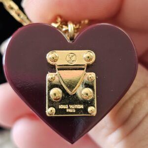 Gold-tone S-lock on the burgundy heart pendant stamped Louis Vuitton Paris