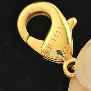 Gold-tone lobster clasp stamped LE1111 on the Louis Vuitton Lock Me heart necklace