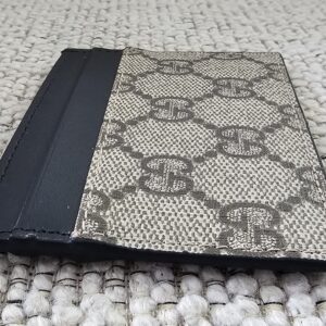 Angled view of the Gucci GG Supreme Essence card holder with black calfskin trim