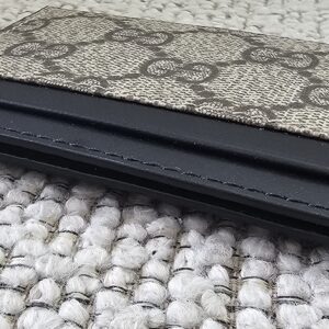 Slim side profile of the Gucci GG Supreme Essence card holder