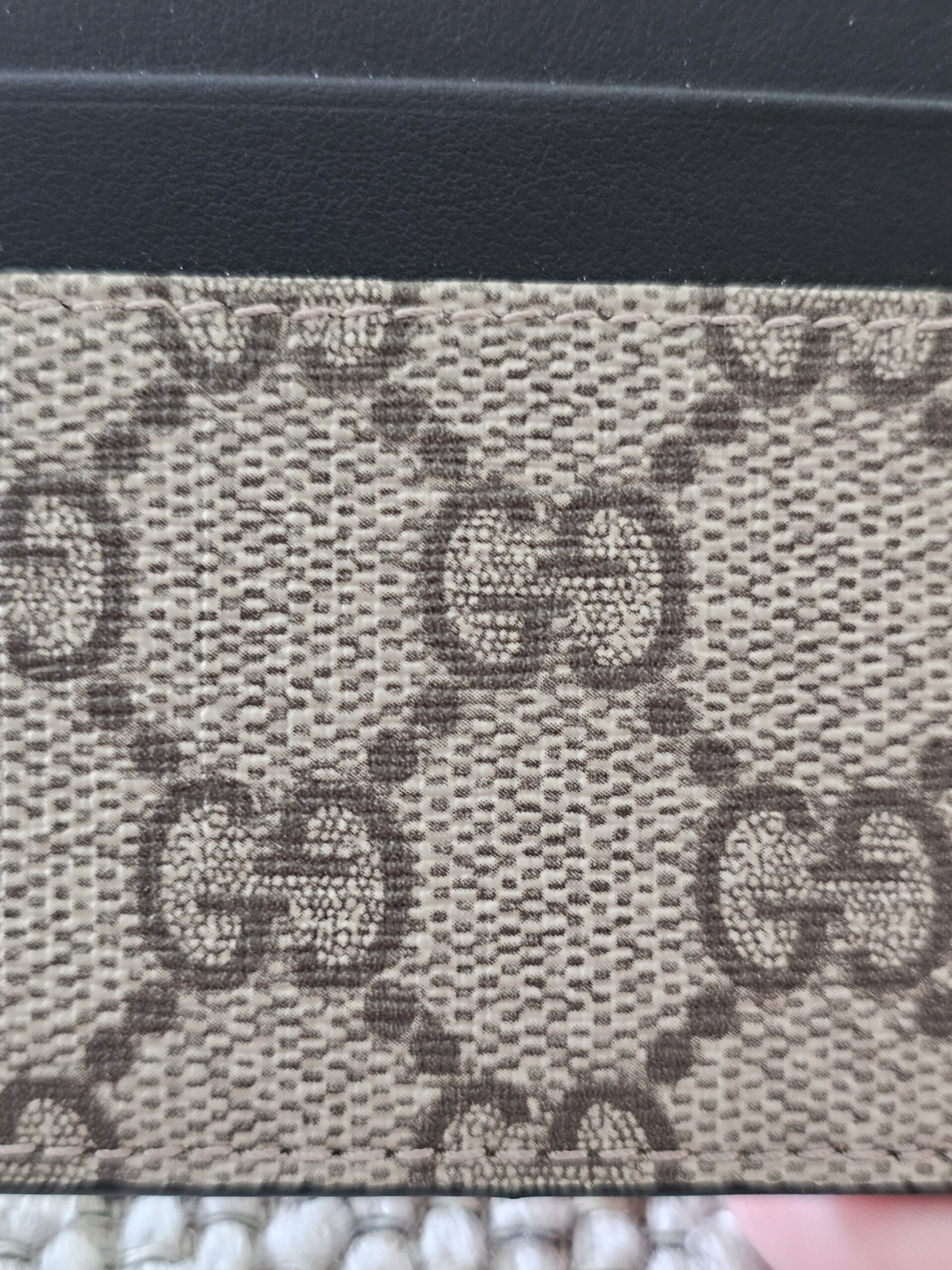 Close-up of the beige and ebony GG Supreme canvas on the Gucci Essence card holder