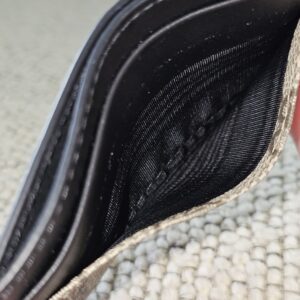 Interior of the Gucci GG Supreme Essence card holder showing the clean center compartment