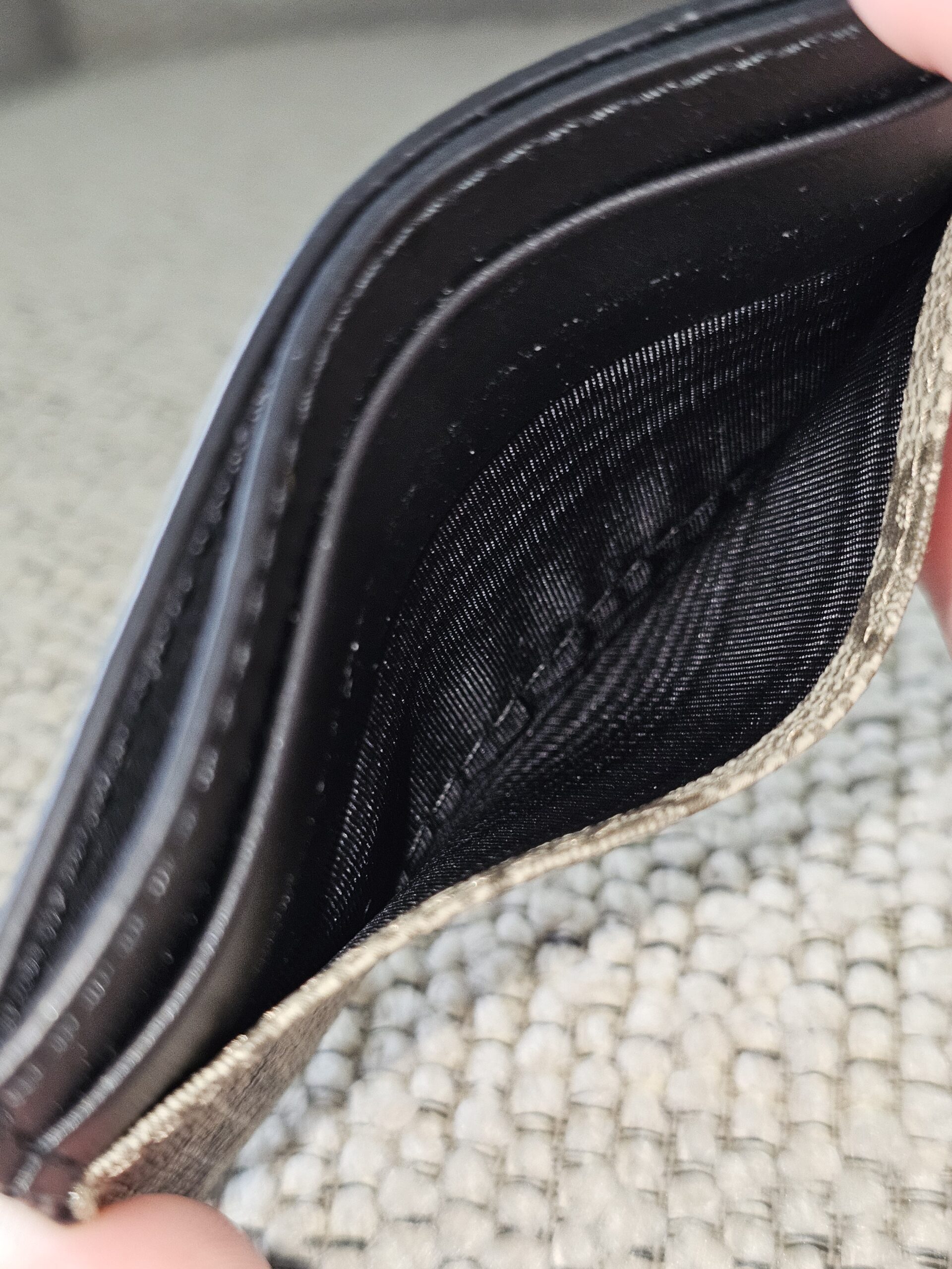 Interior of the Gucci GG Supreme Essence card holder showing the clean center compartment