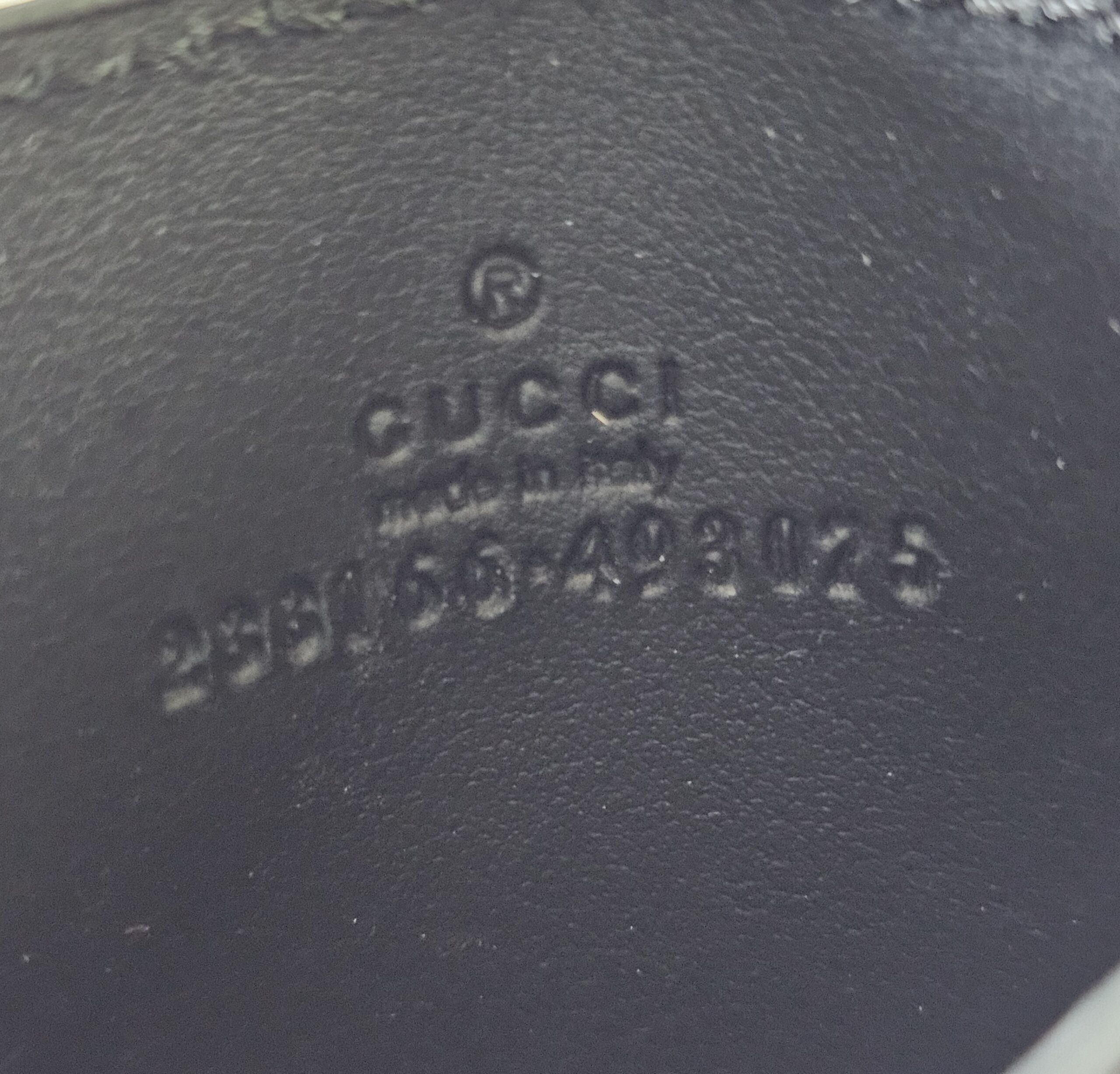 Style code 233166 embossed inside the Gucci GG Supreme Essence card holder
