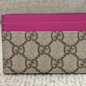 Front of the Gucci Essence card holder showing the GG Supreme canvas and pink calfskin card slots
