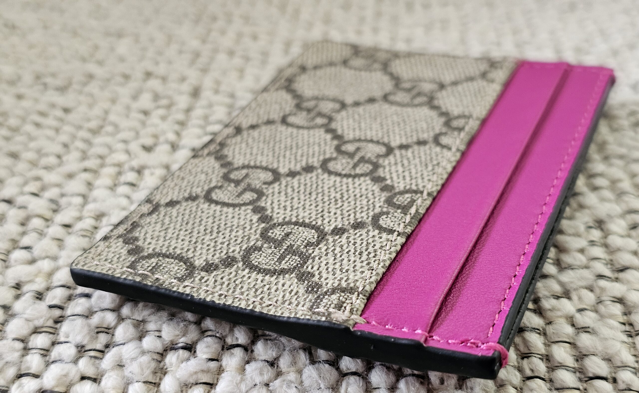 Pink calfskin card slots on the Gucci GG Supreme Essence card holder