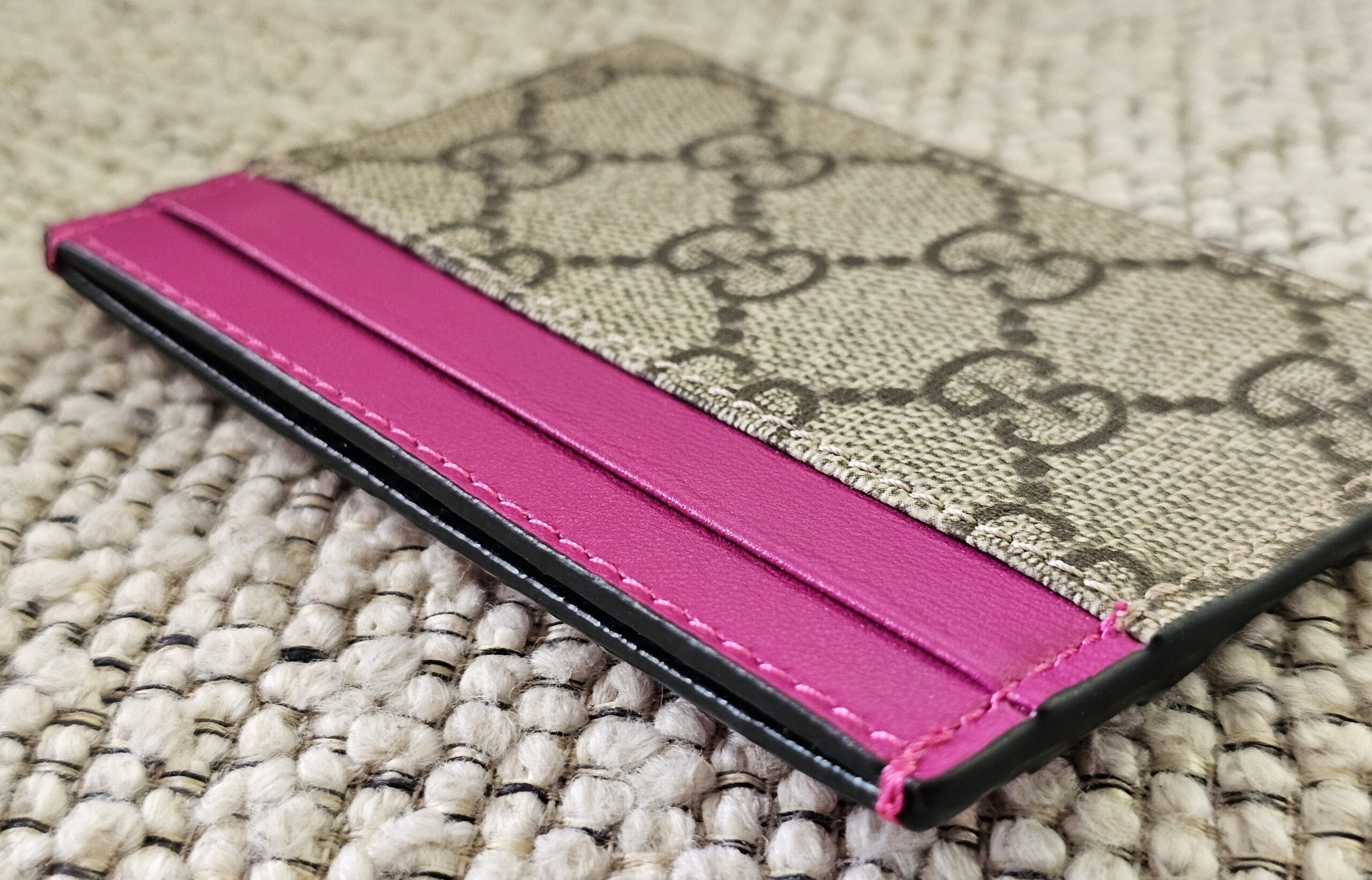 Slim side profile of the Gucci GG Supreme Essence card holder in pink calfskin