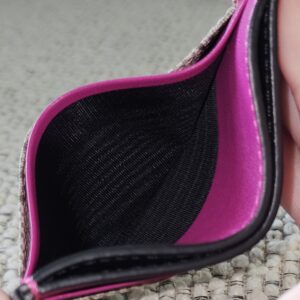 Interior of the Gucci GG Supreme Essence card holder showing the pink calfskin and clean black lining