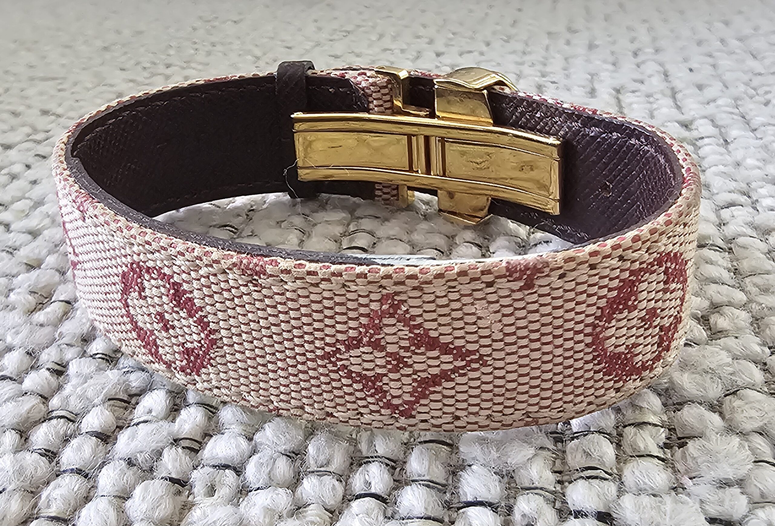 Gold-tone clasp and burgundy leather lining of the Louis Vuitton Millennium Wish bracelet