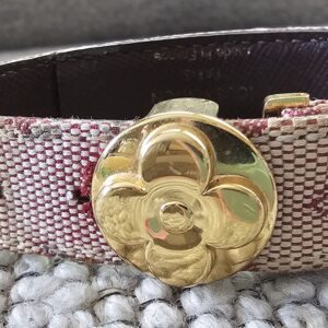 Gold-tone LV flower closure on the Louis Vuitton Monogram Mini Lin Millennium Wish bracelet