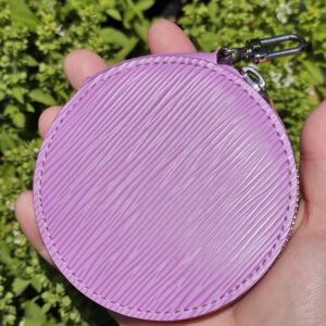 Matching round Louis Vuitton coin pouch in purple Epi leather held in hand