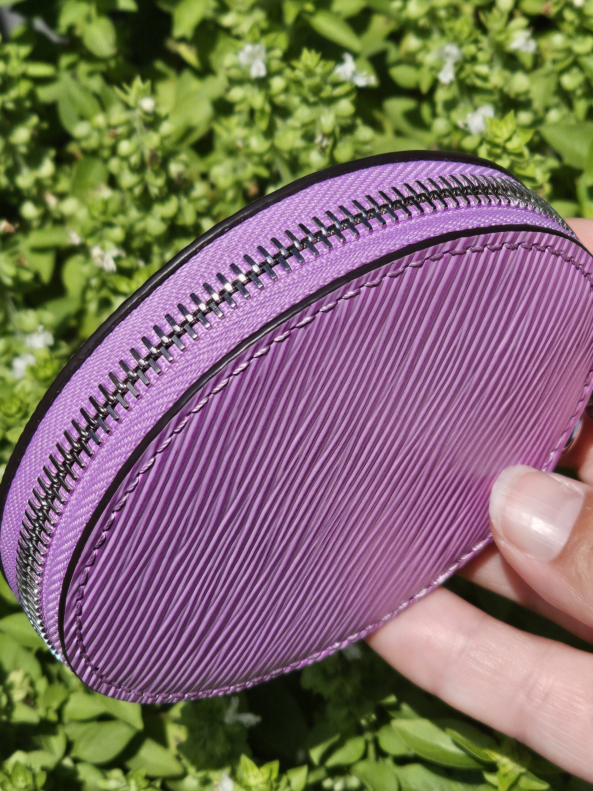 Silver-tone zip around the round purple Epi coin pouch