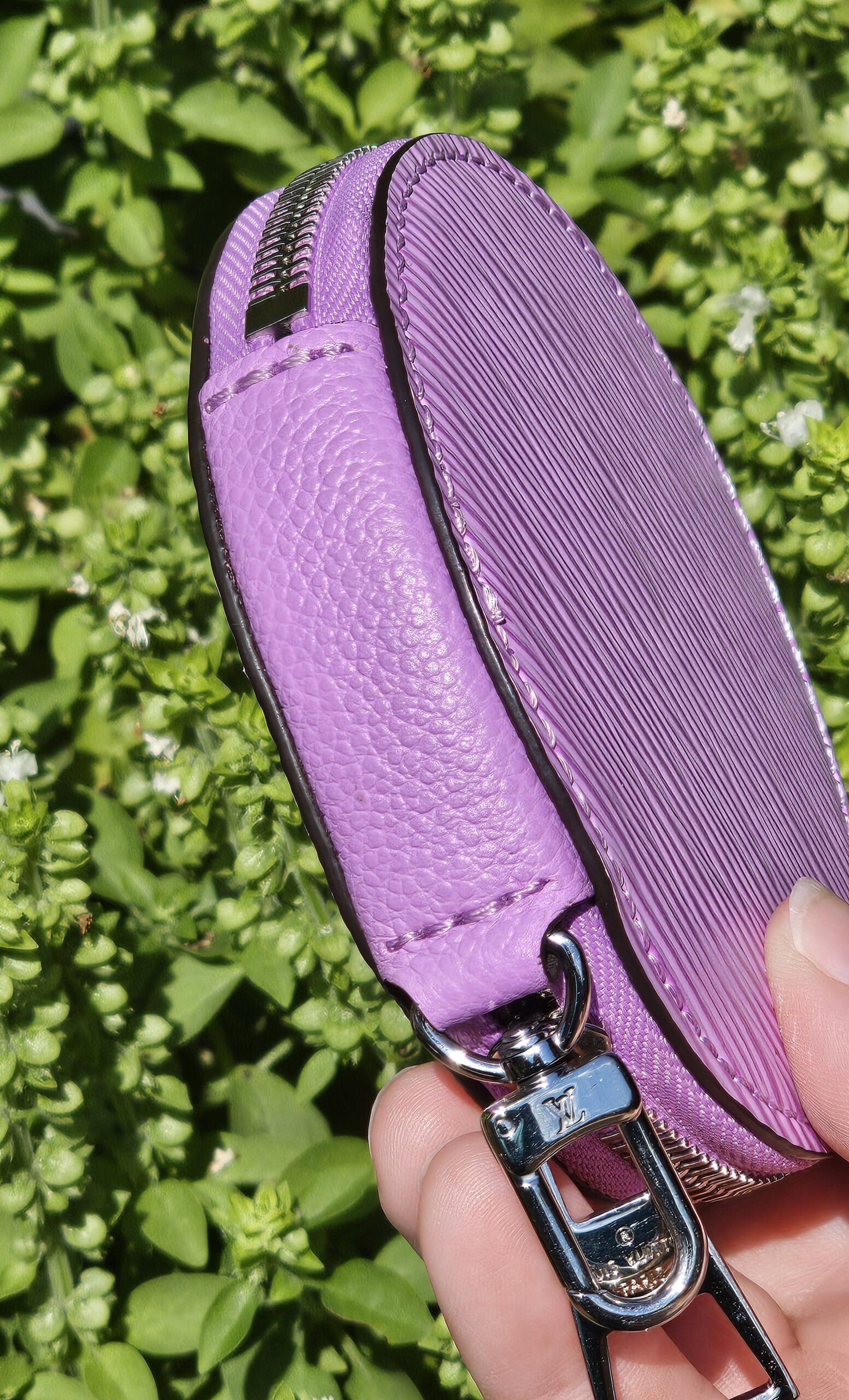 Side profile of the round purple Epi coin pouch from the Louis Vuitton Marellini set