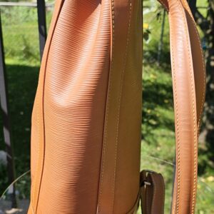 Side profile of the Louis Vuitton Epi Randonnee PM showing the backpack strap