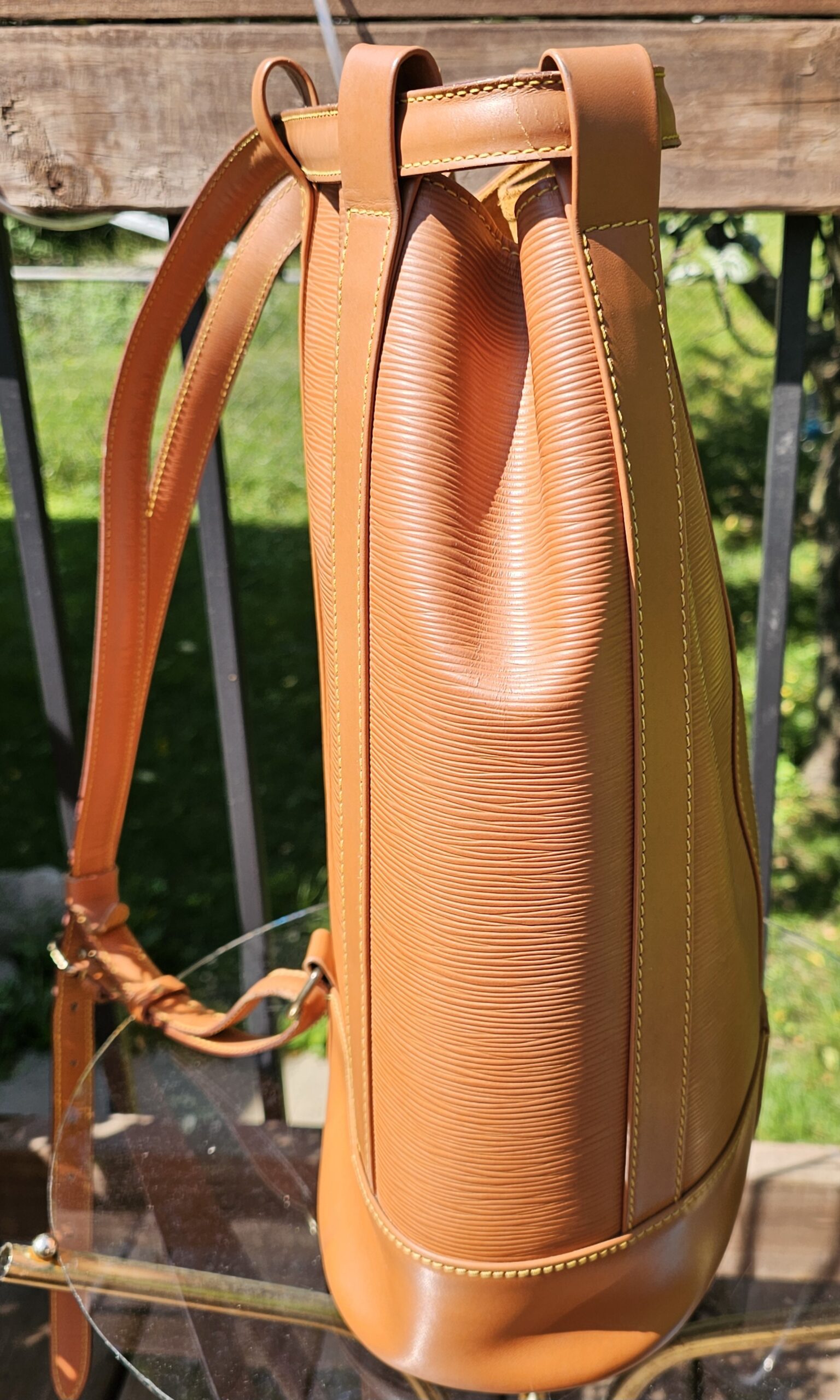 Back of the Louis Vuitton Epi Randonnee PM showing the leather backpack straps