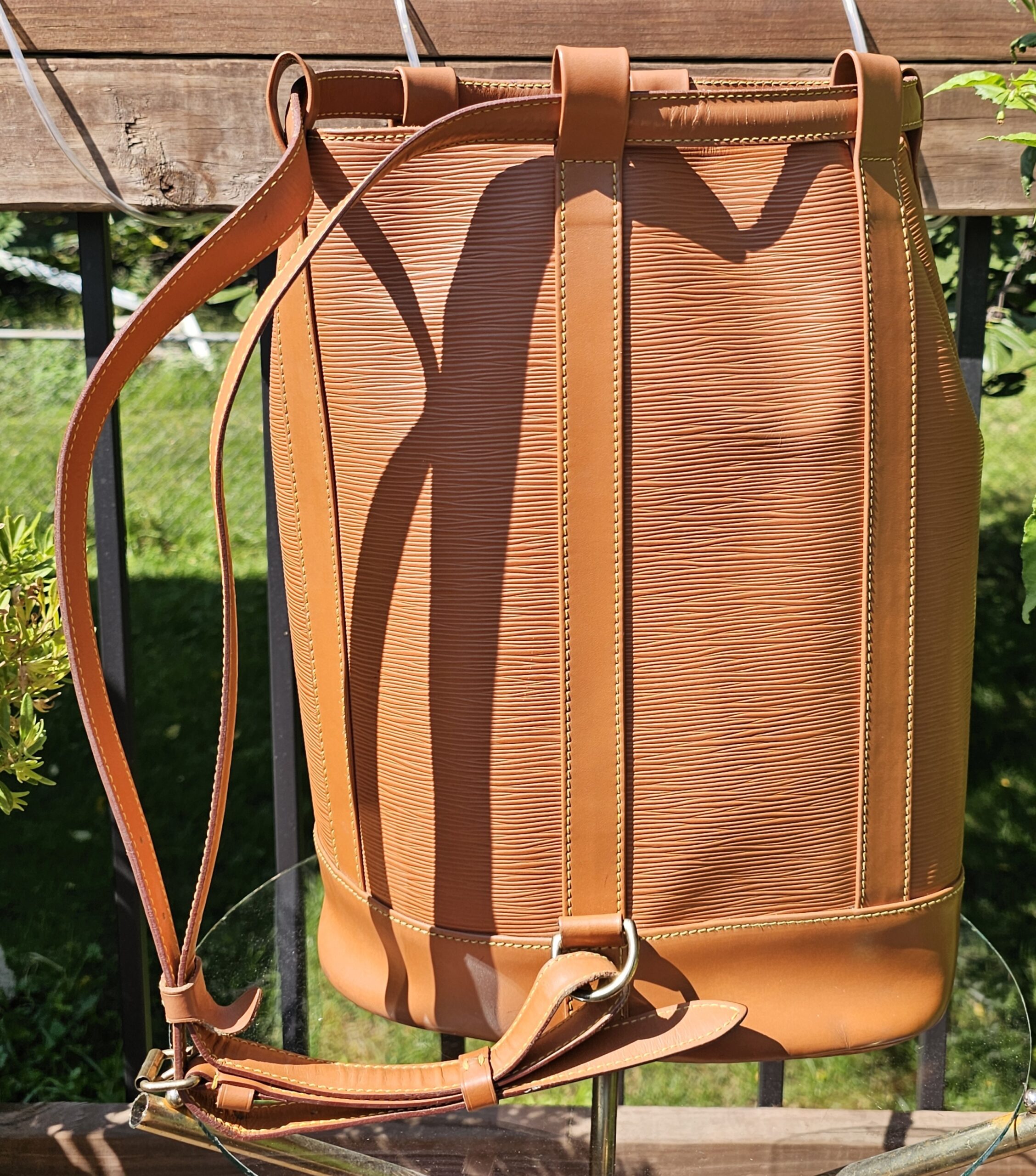 Leather shoulder straps of the Louis Vuitton Epi Randonnee PM backpack