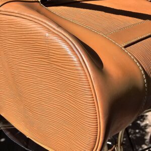 Base edge and stitching of the Louis Vuitton Epi Randonnee PM shown for vintage wear