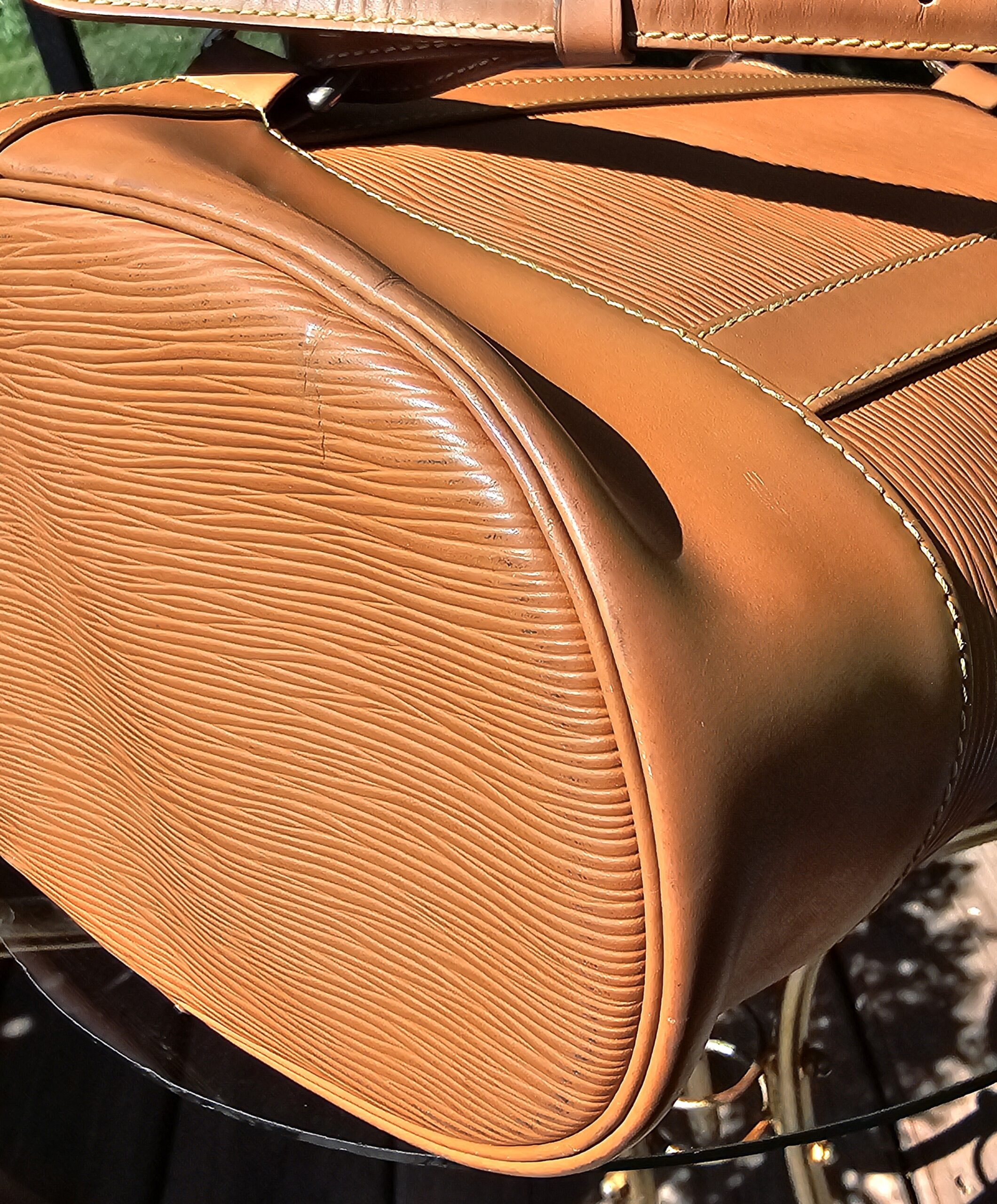 Base edge and stitching of the Louis Vuitton Epi Randonnee PM shown for vintage wear