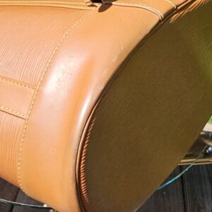 Bottom of the Louis Vuitton Epi Randonnee PM backpack shown for condition