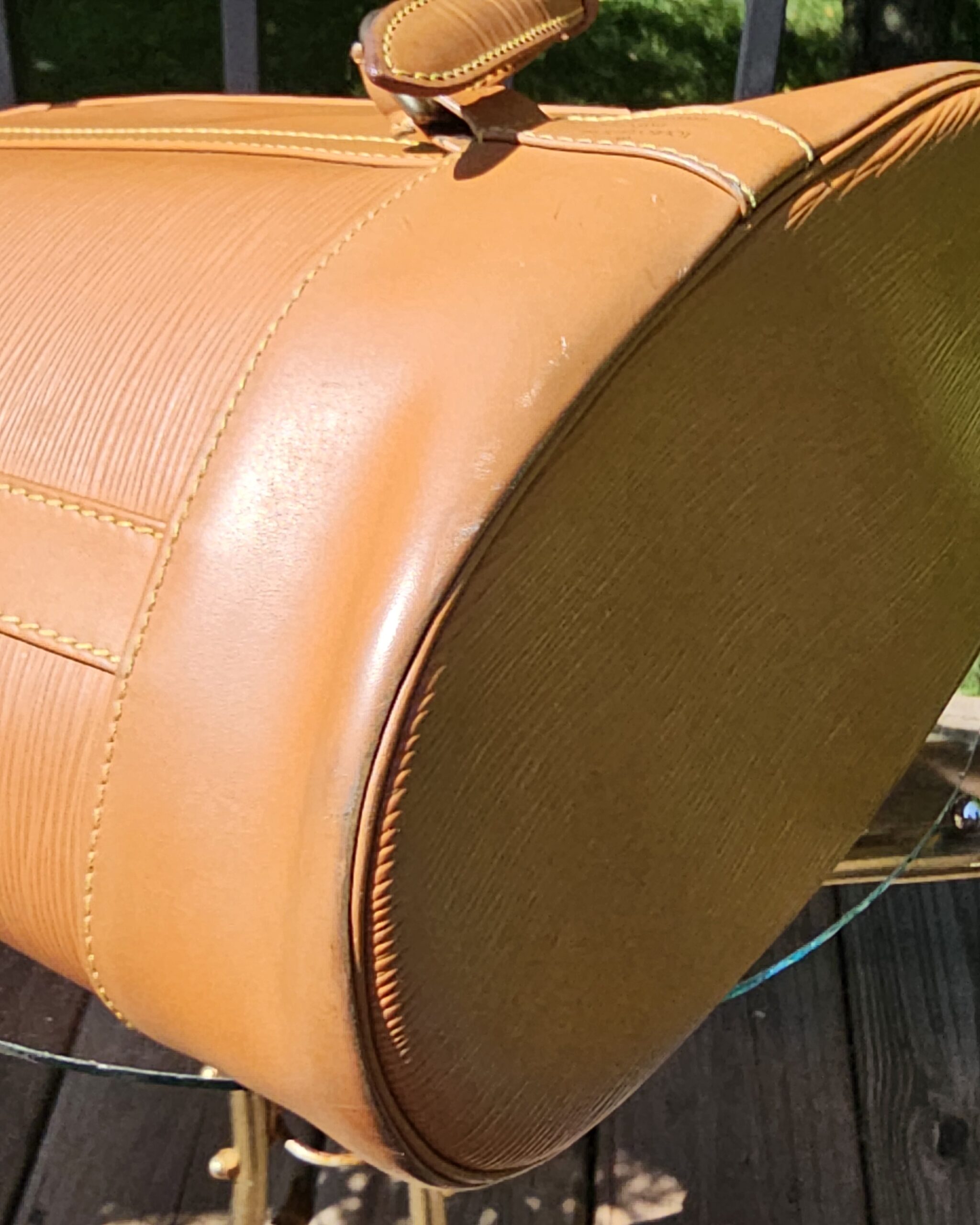 Bottom of the Louis Vuitton Epi Randonnee PM backpack shown for condition