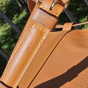 Gold-tone buckle hardware on the cinch closure of the Louis Vuitton Epi Randonnee PM