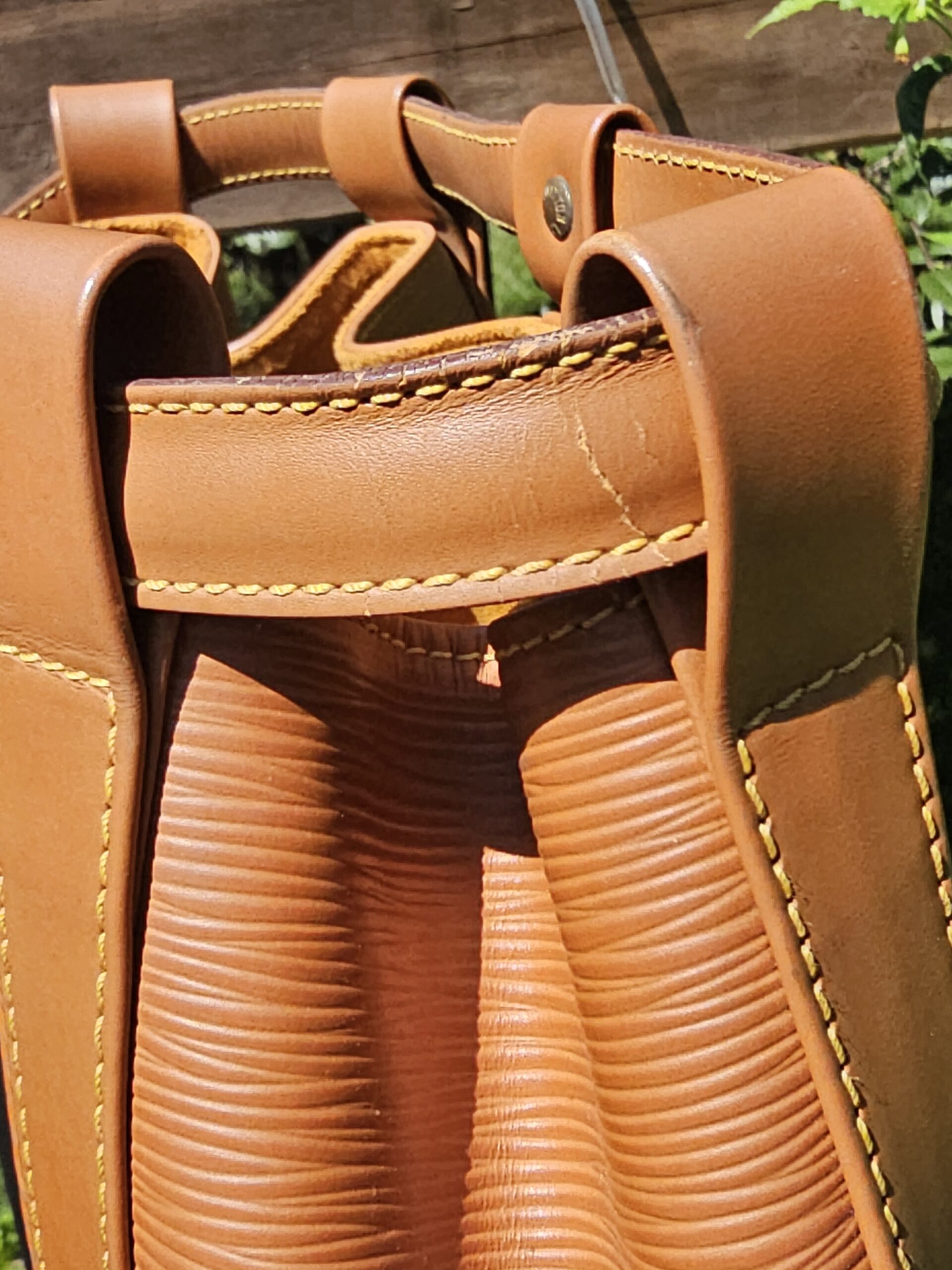 Top of the Louis Vuitton Epi Randonnee PM with the drawstring cinch and straps