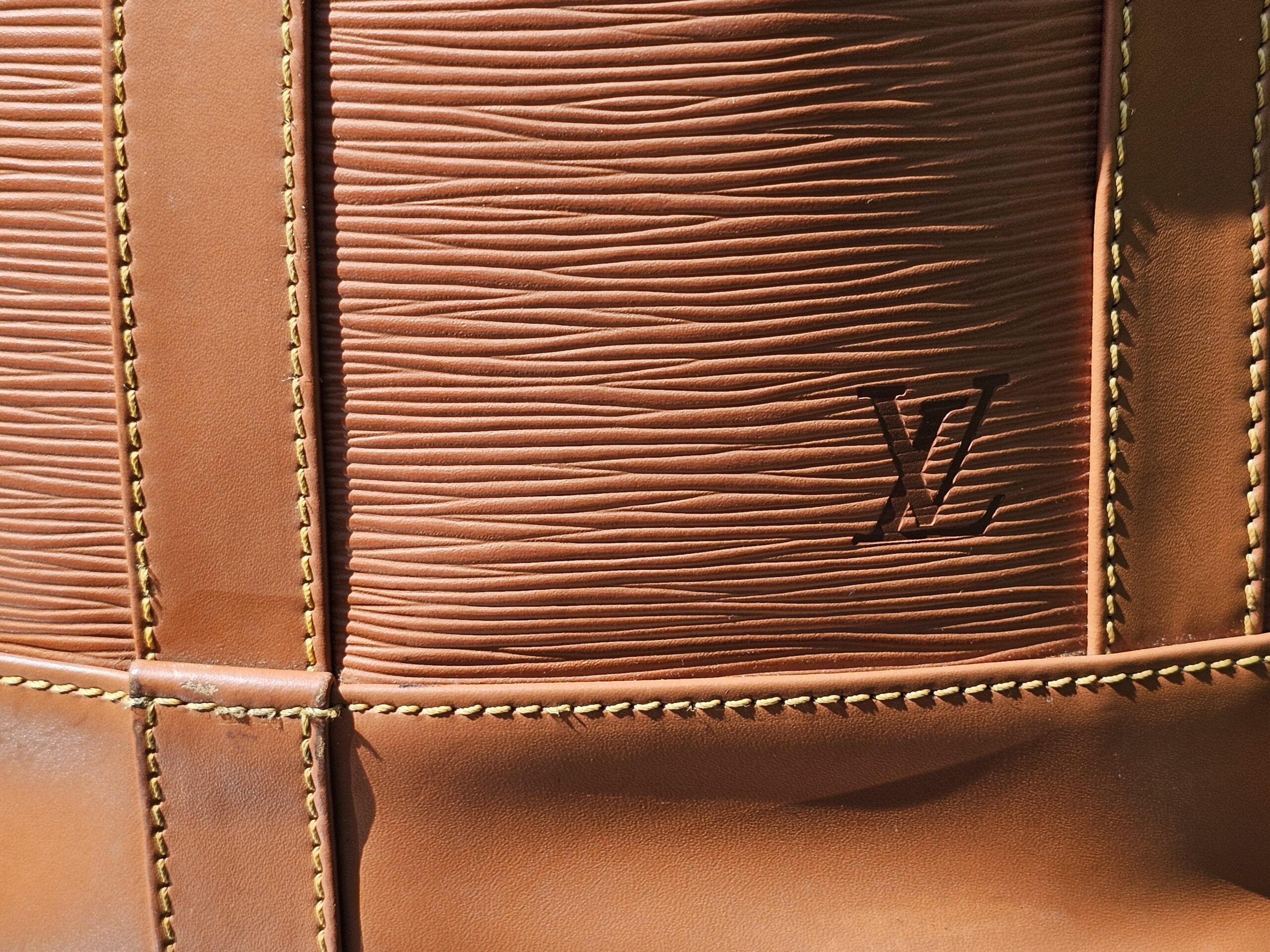 LV embossed on the Cipango Gold Epi kisslock wallet included with the Randonnee PM