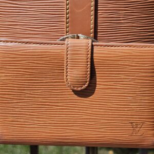 Front of the coordinating Louis Vuitton Epi kisslock wallet in Cipango Gold