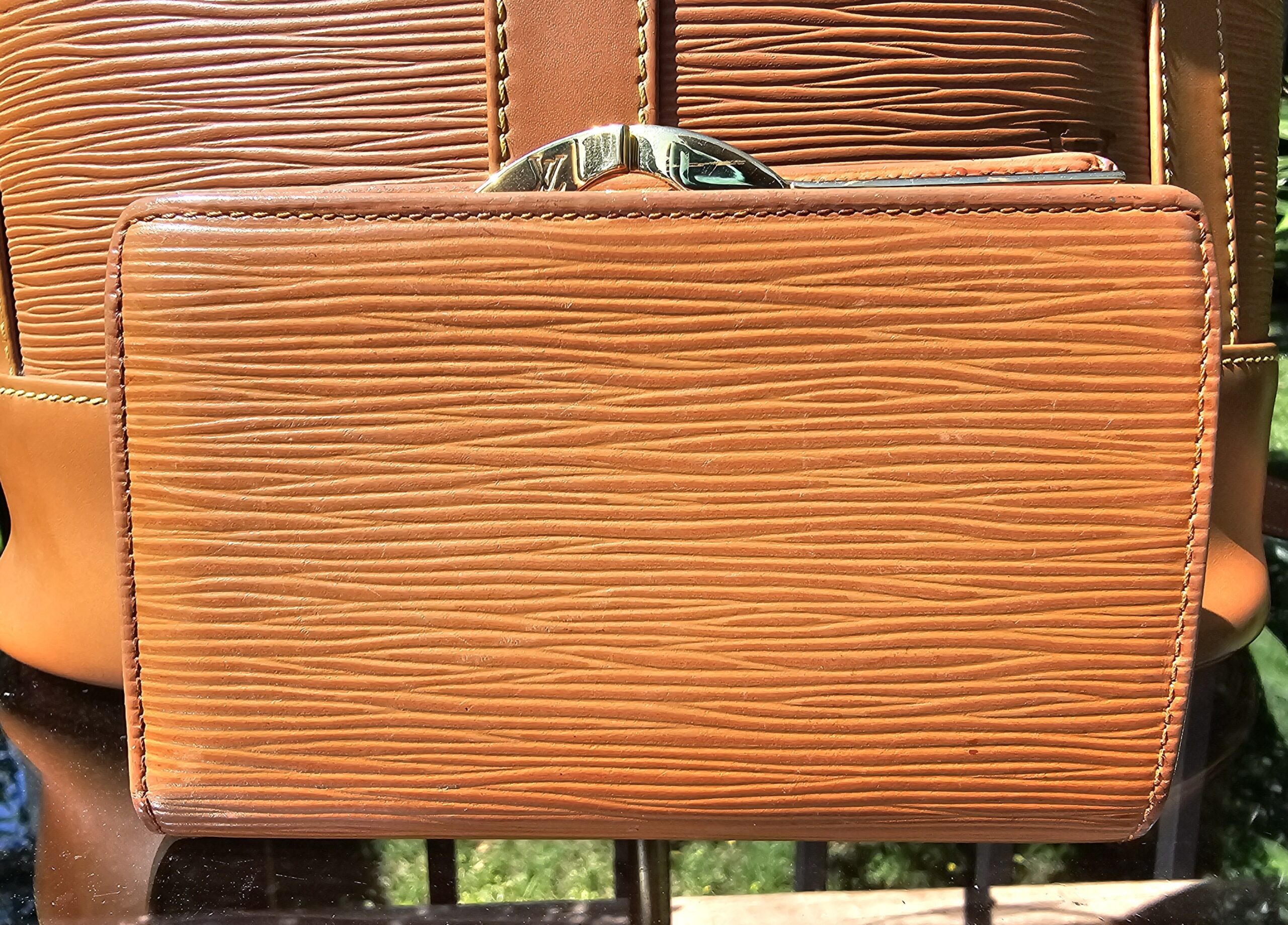 Back of the Louis Vuitton Epi kisslock wallet in Cipango Gold leather