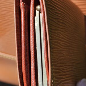 Interior of the Louis Vuitton Epi kisslock wallet showing card slots and bill compartments