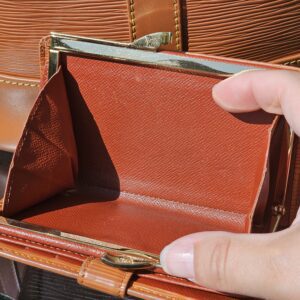 Brass kisslock frame and coin compartment of the Louis Vuitton Epi wallet