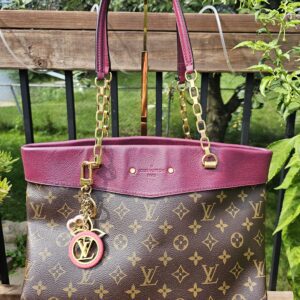 Louis Vuitton Colorline key holder and bag charm hanging from a Monogram tote, shown for scale and styling