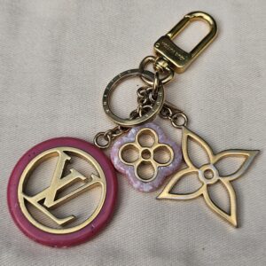 Louis Vuitton Colorline key holder and bag charm with a pink resin LV medallion, floral charm and gold-tone Monogram flower