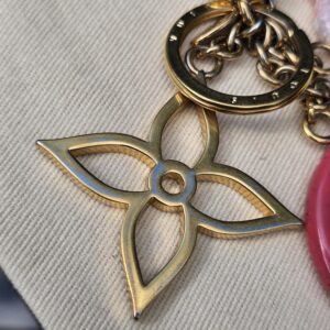 Gold-tone Monogram flower charm on the Louis Vuitton Colorline bag charm