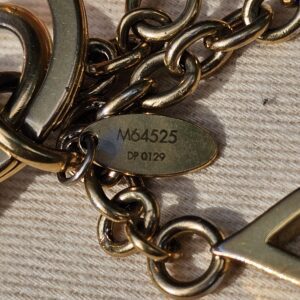 Plaque stamped M64525 and date code DP0129 on the Louis Vuitton Colorline bag charm