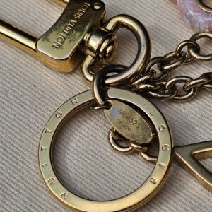 Gold-tone key ring and Louis Vuitton engraved clasp on the Colorline key holder and bag charm
