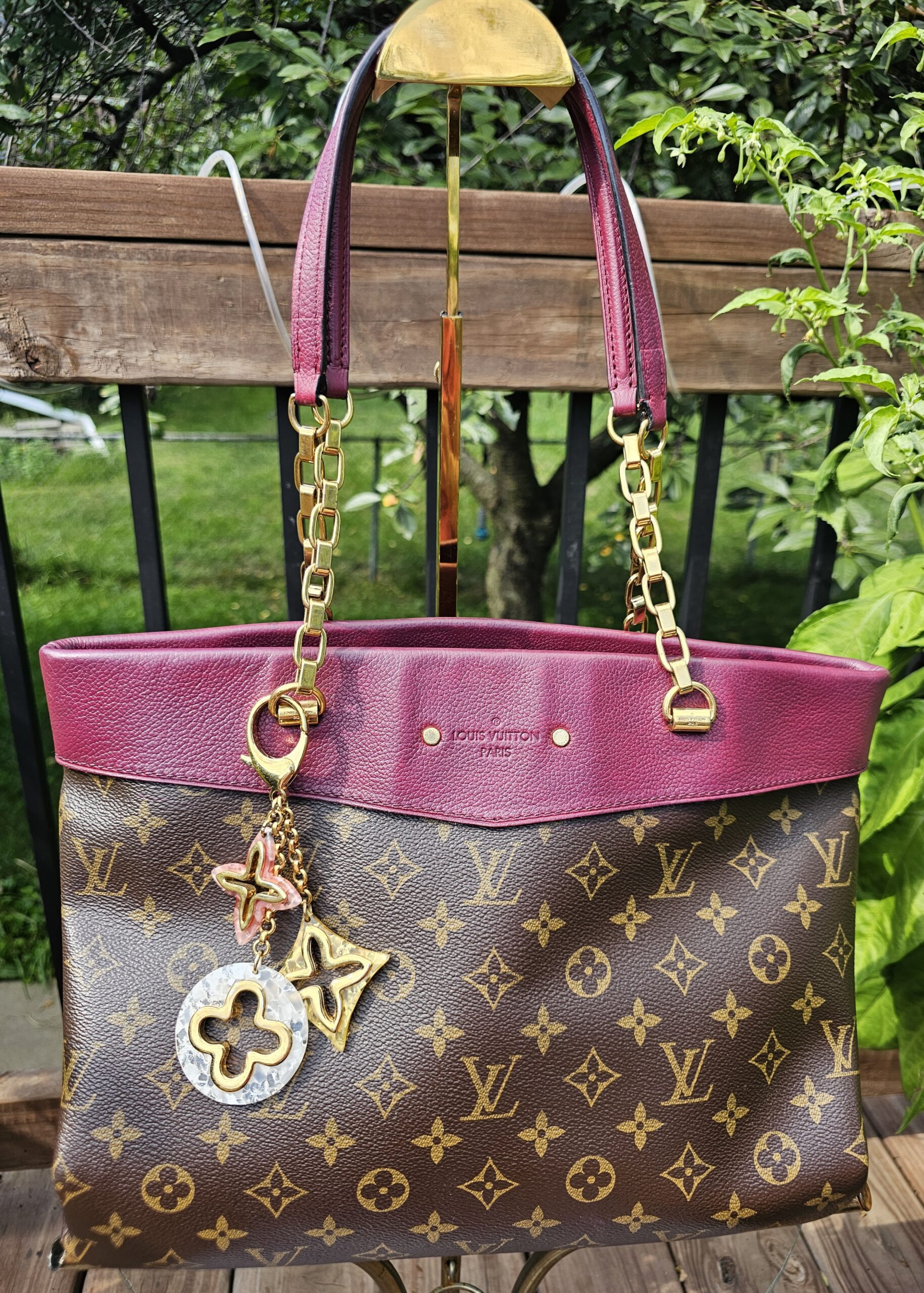 Louis Vuitton Insolence key holder and bag charm hanging from a Monogram tote, shown for scale and styling