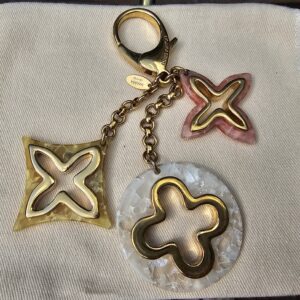 Louis Vuitton Insolence key holder and bag charm with pink, yellow and pearly white resin Monogram charms on a gold-tone chain